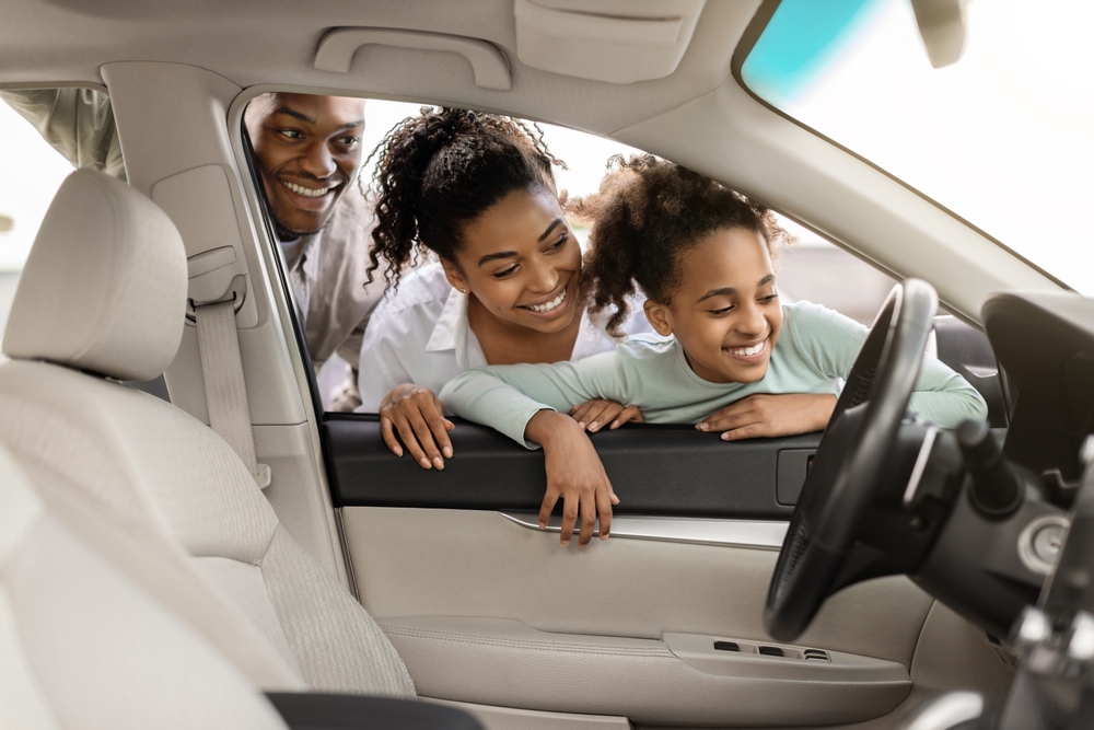 family smiles looking into auto interior - article about high-viscosity white oil