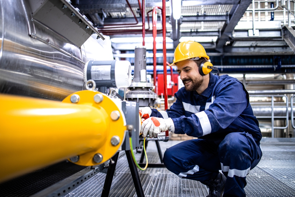 Specialty oil refinery operator working with a pipeline, interior