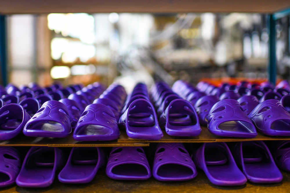 two stacked rows of purple sandals made with synthetic rubber manufacturing and process oils