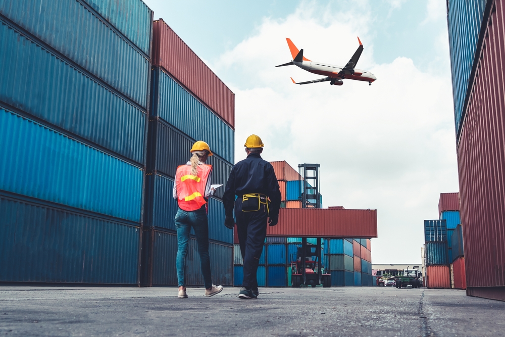 Industrial workers walk through an overseas shipping container port - article on specialty oil supply chain transparency