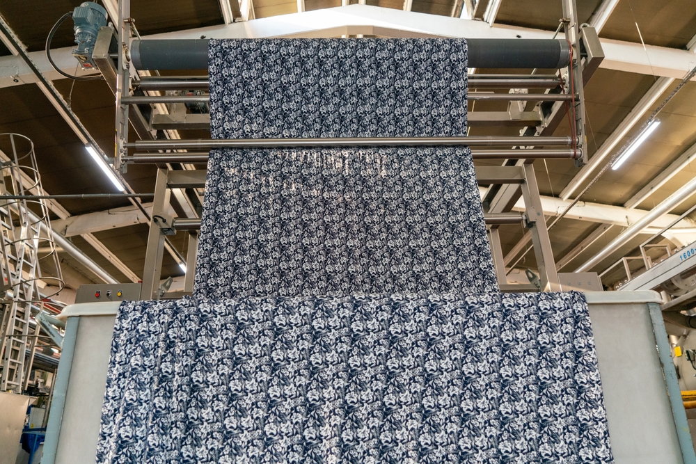 Fabric machine industrial plant line in a textile factory - article about how white oil suppliers support textile manufacturing